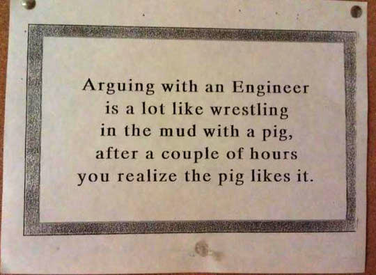funny-arguing-engineer-wrestling-pig